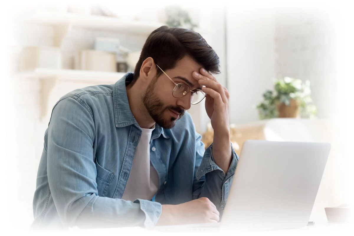 Man looking concernedly at laptop