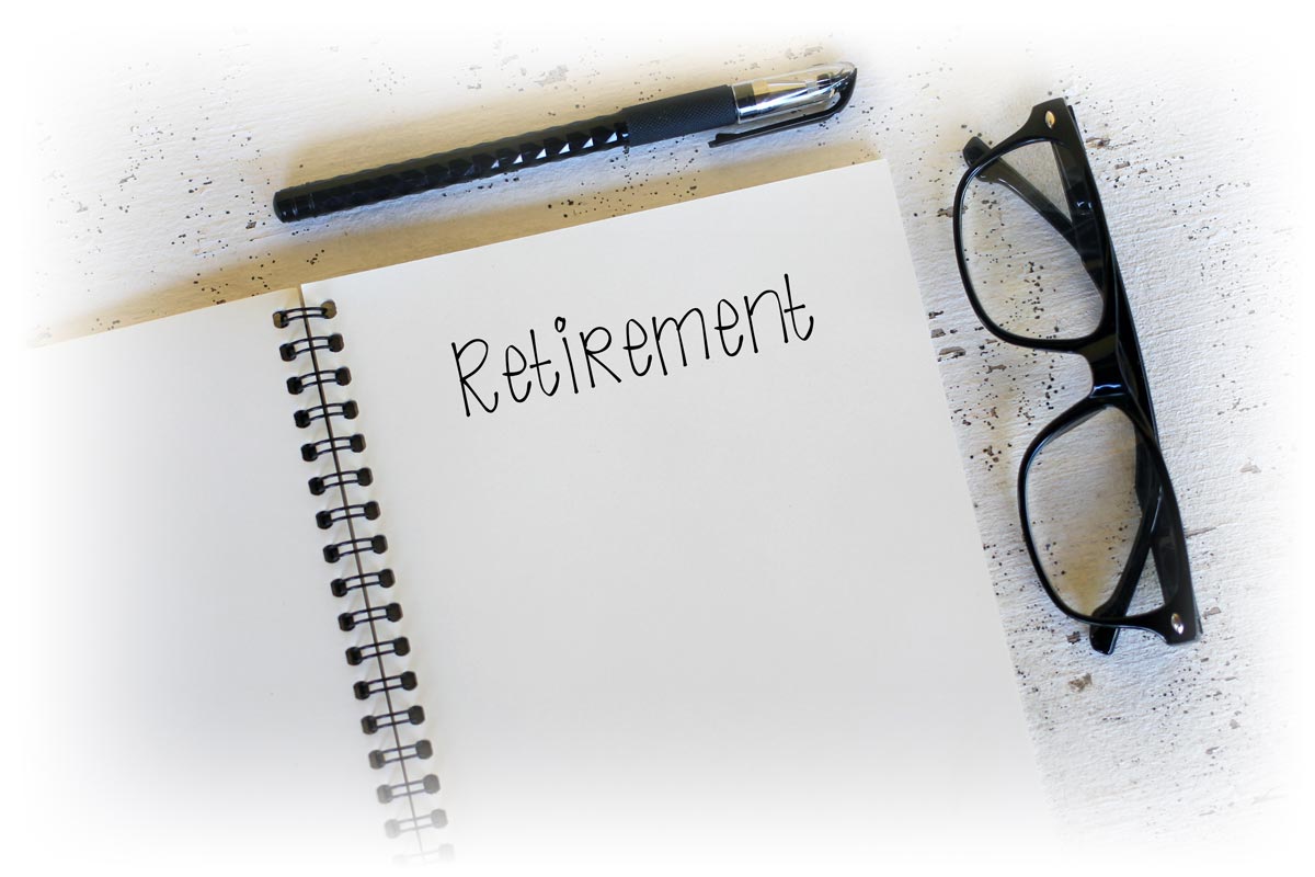 Notepad_reading_RETIREMENT_1200px Notepad reading "RETIREMENT" next to glasses and pen