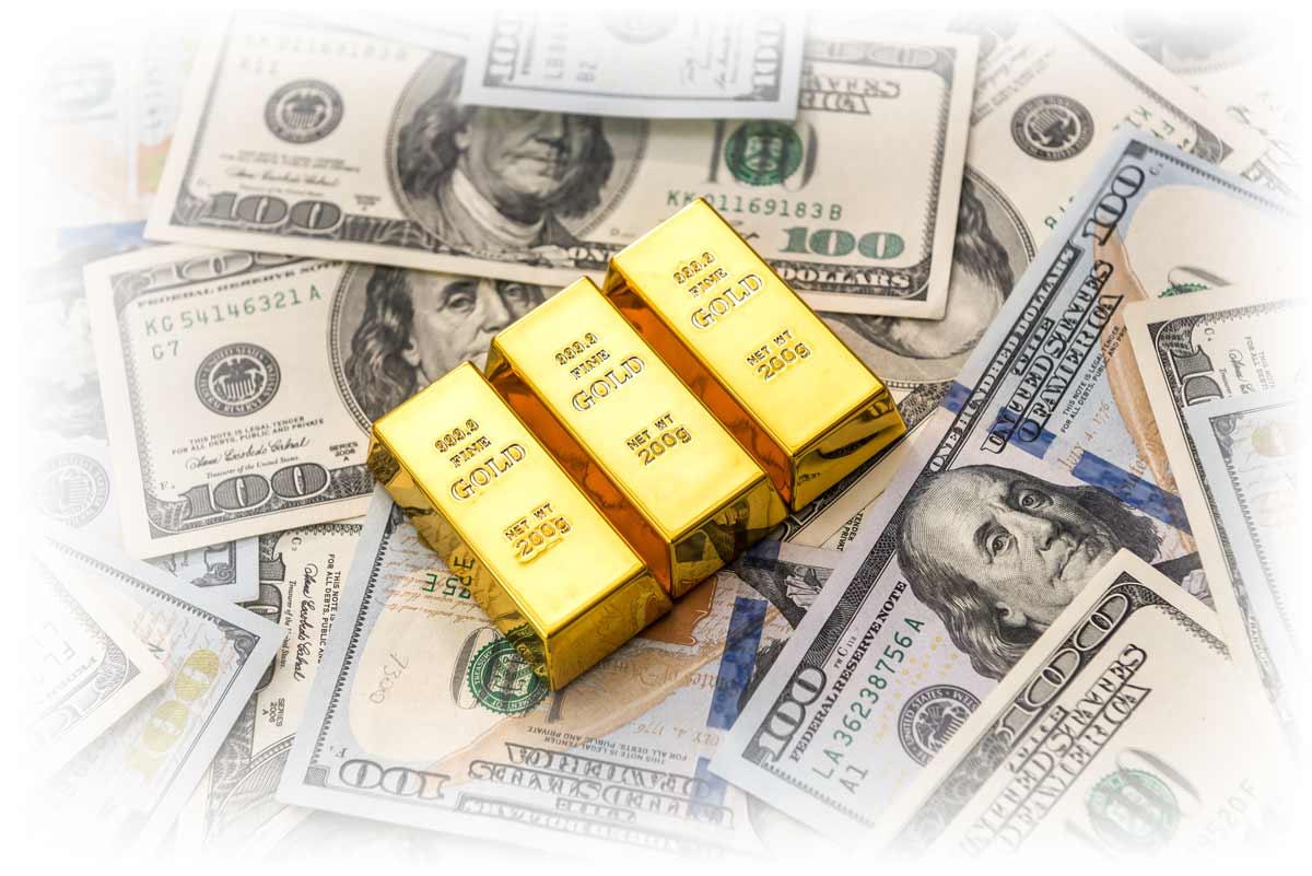 Three gold bars on top of pile of $100 notes