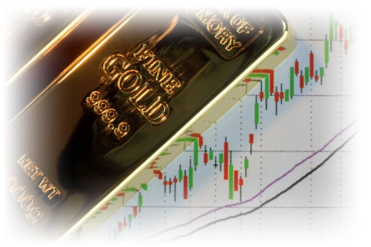 Gold bars on print-out of upward-trending market data