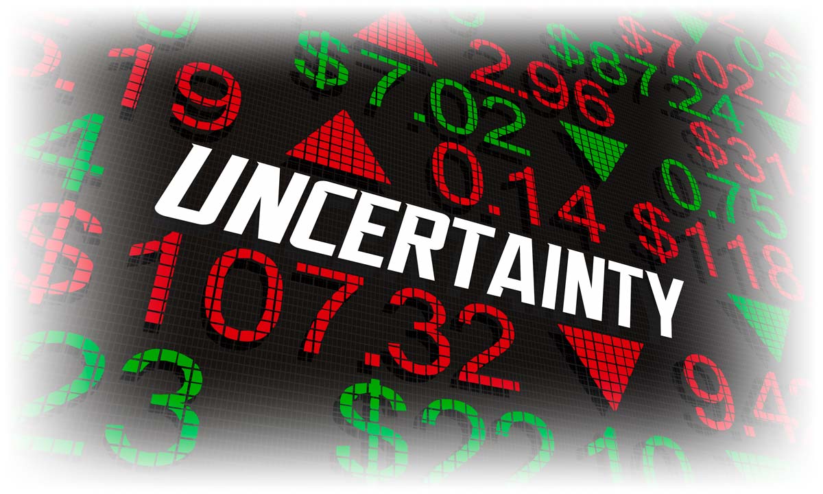 Board with stock data and word "UNCERTAINTY"