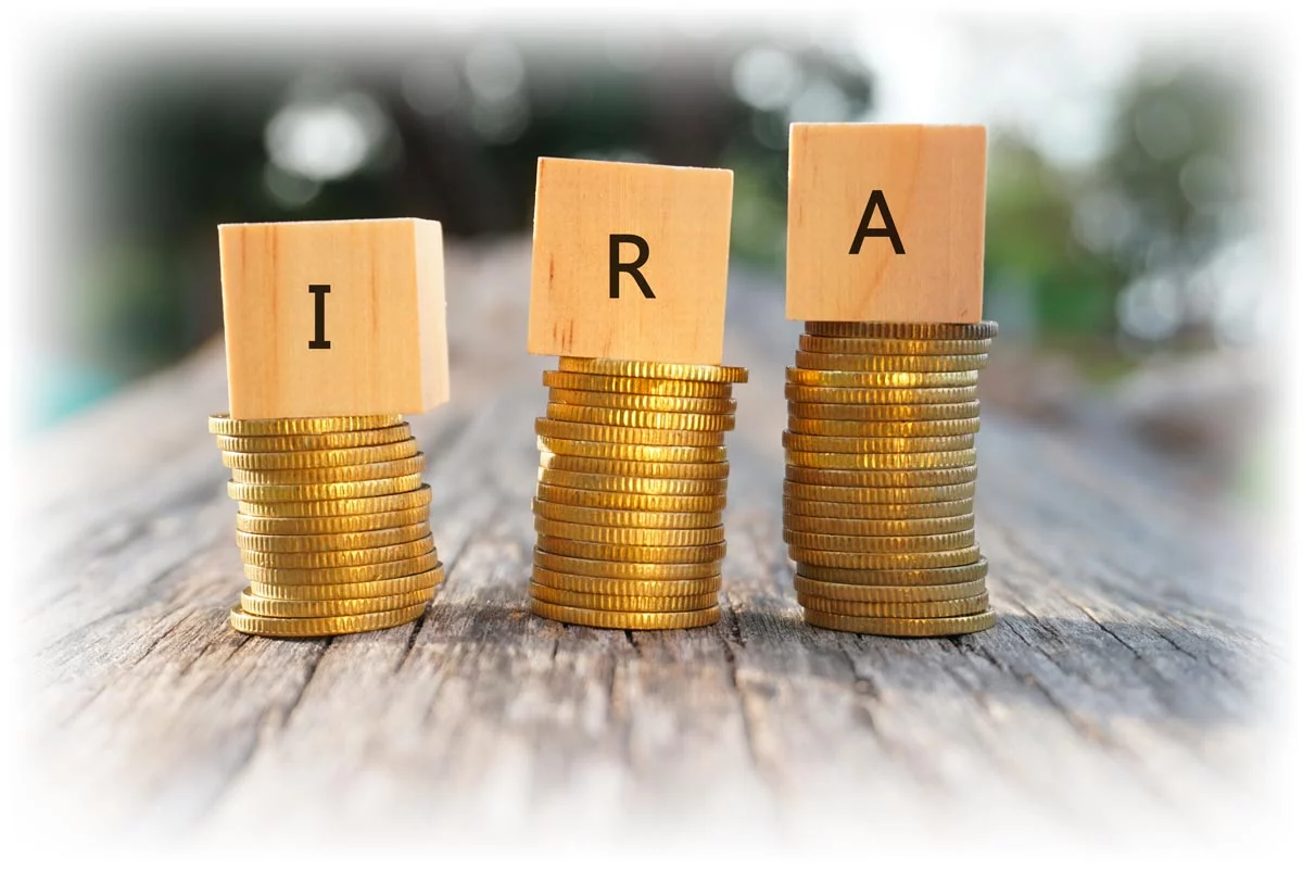 Wood blocks spelling "IRA" on stacks of gold coins