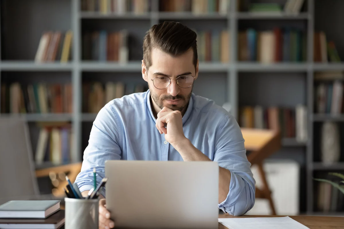 Businessman reading on laptop