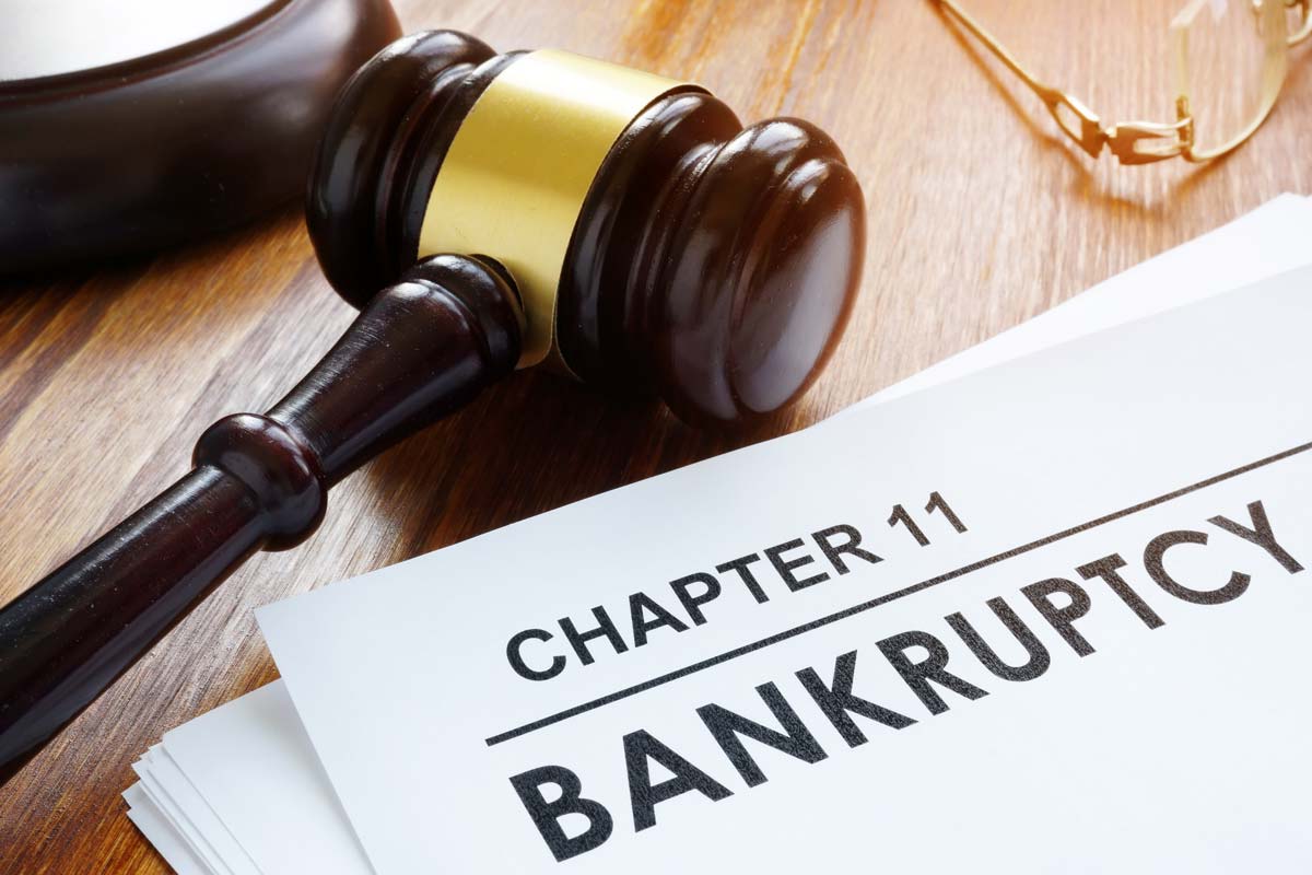 Gavel next to paperwork titled "CHAPTER 11 BANKRUPTCY"