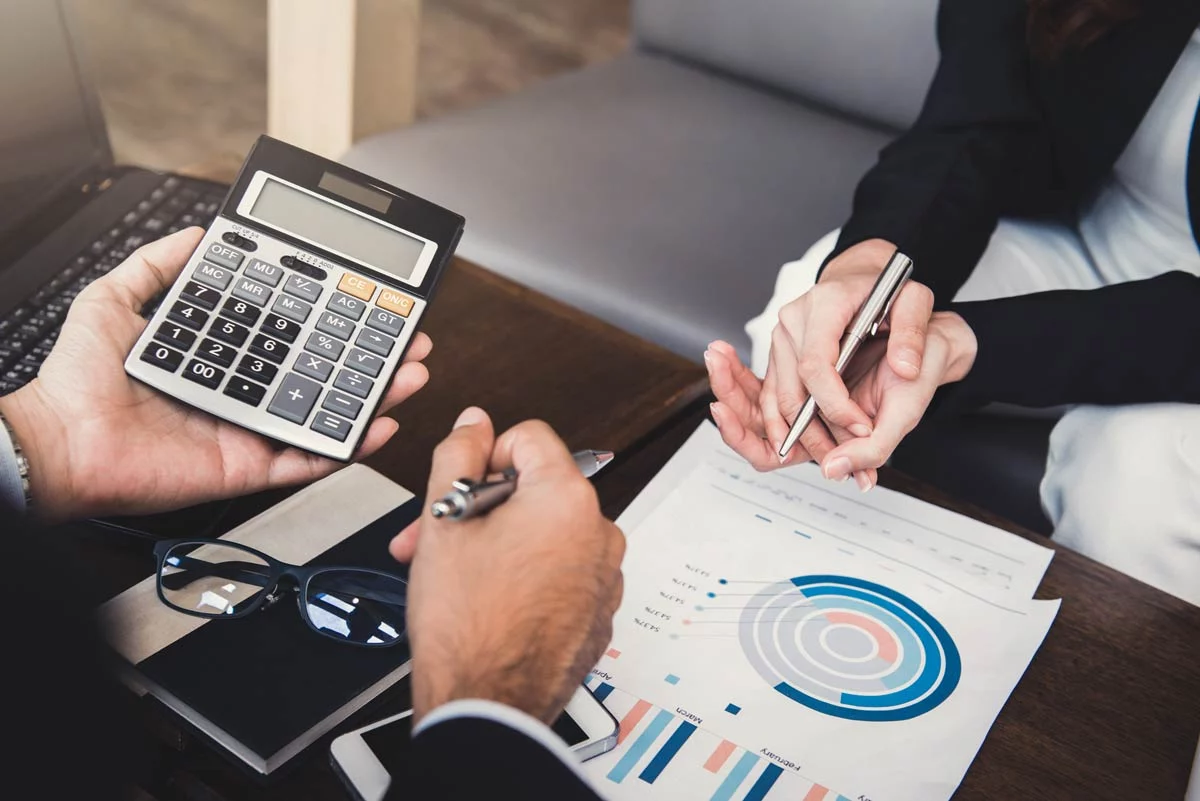 Hands of advisor and client working on financial plan