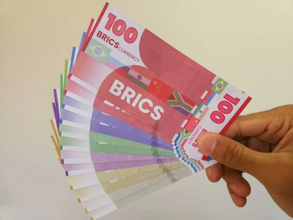 Hand holding artist's rendition of proposed BRICS currency