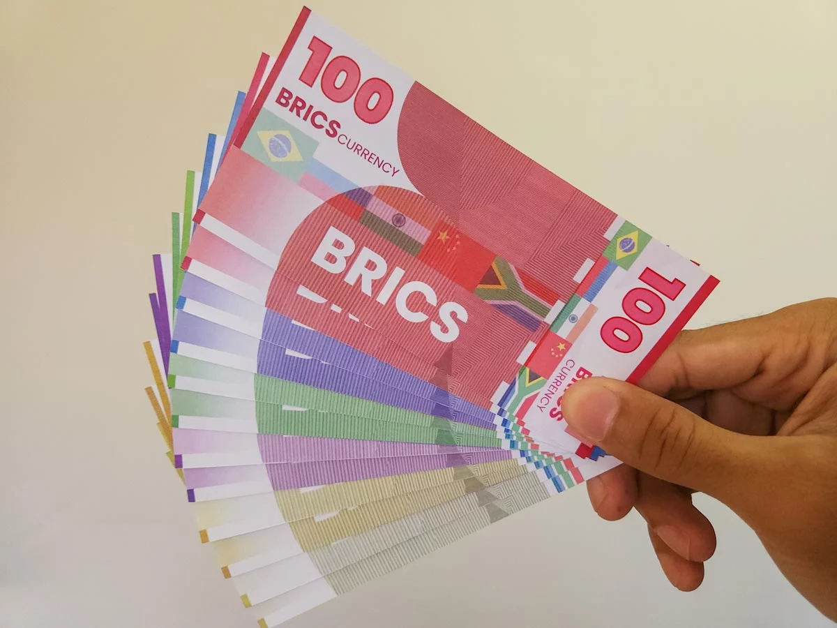 Hand holding artist's rendition of proposed BRICS currency