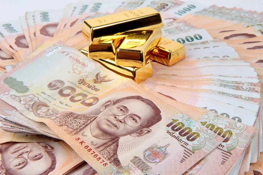Gold bars on fan of Thailand 1000 baht notes