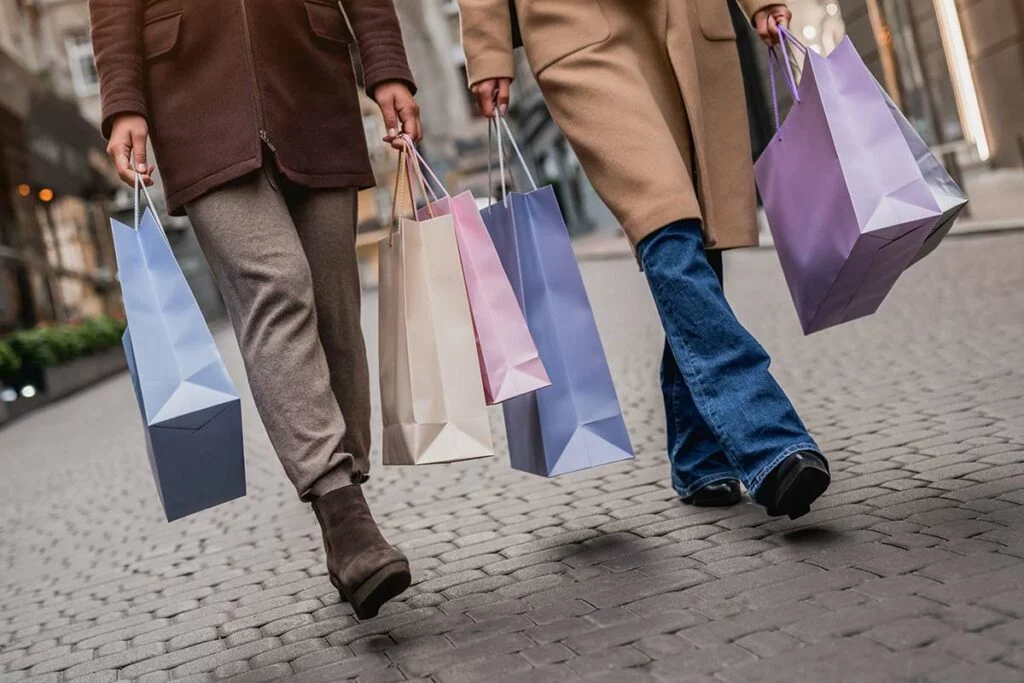 Shopping bags being carried by two women walking