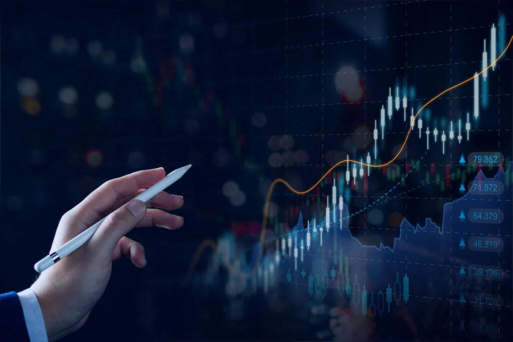 Hand with stylus pointed at stock data