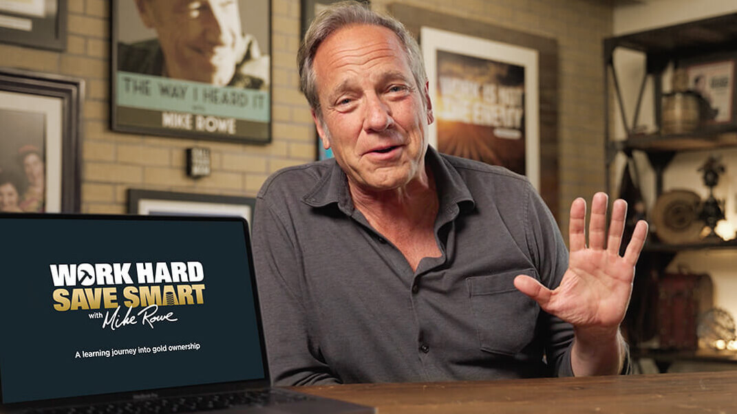 mike rowe waving next to laptop