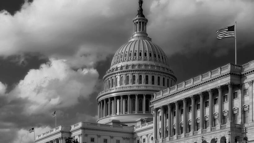 US Capitol dome with stormy sky.