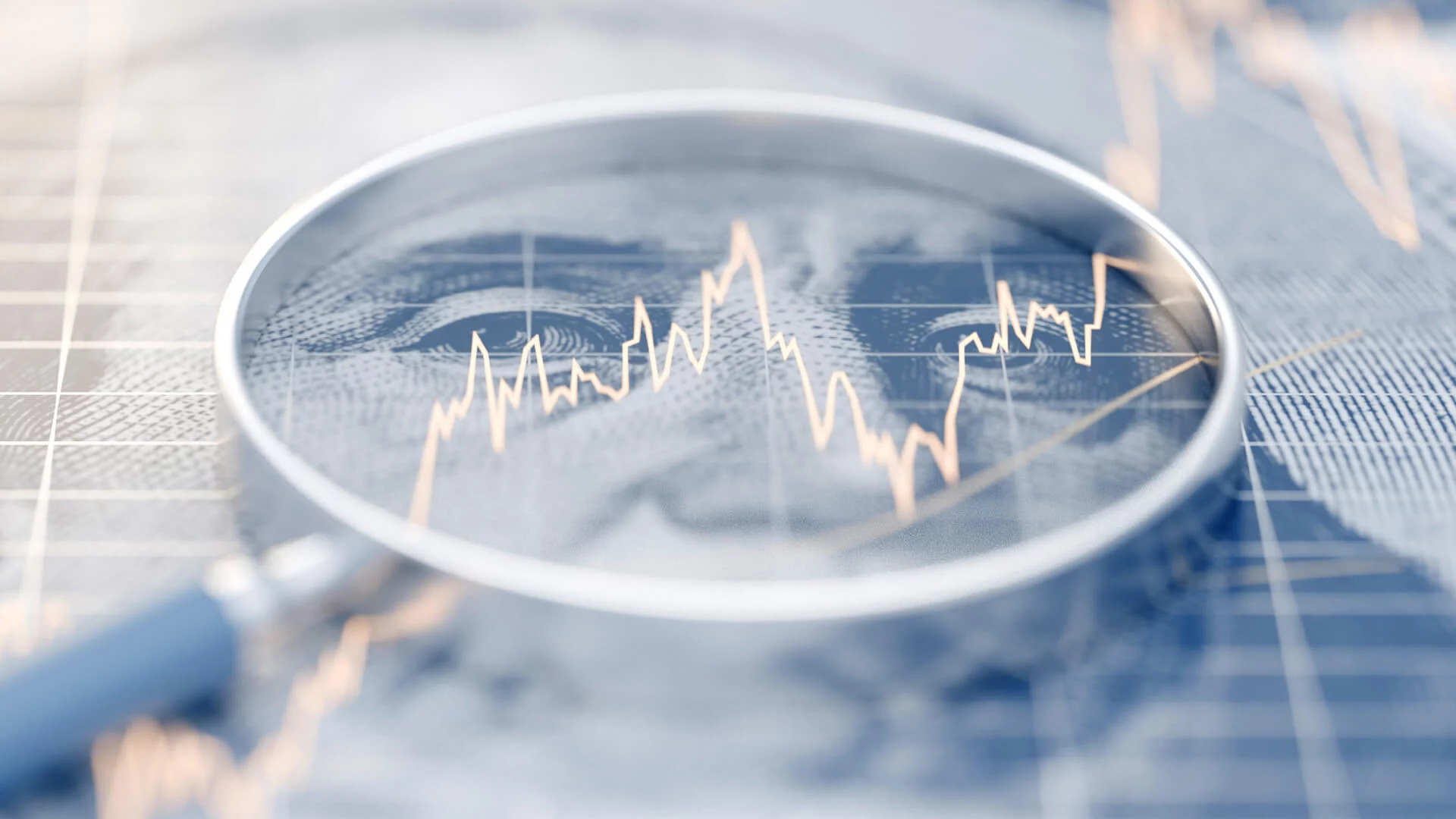 Magnifying glass over dollar bill with graph