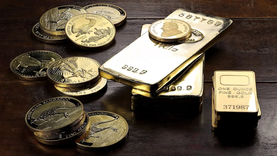 Gold coins and bars on wooden surface. Gold coins and bars on wooden surface.