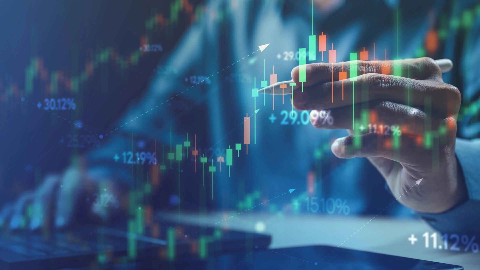 Hand with pen analyzing stock market data